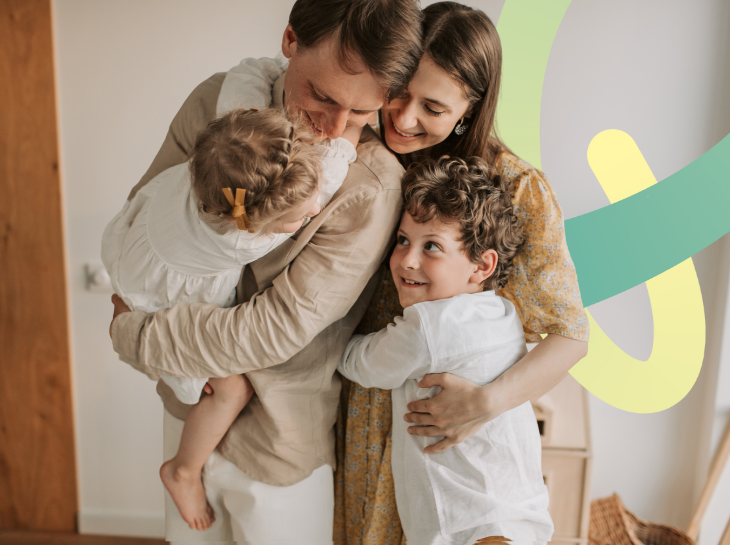 Family of four indoors with a colourful  P graphic in the background