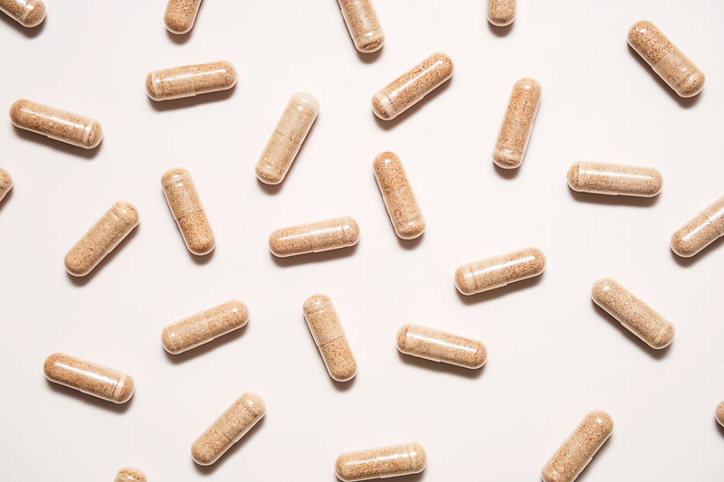 Pattern of brown capsules on a light beige background